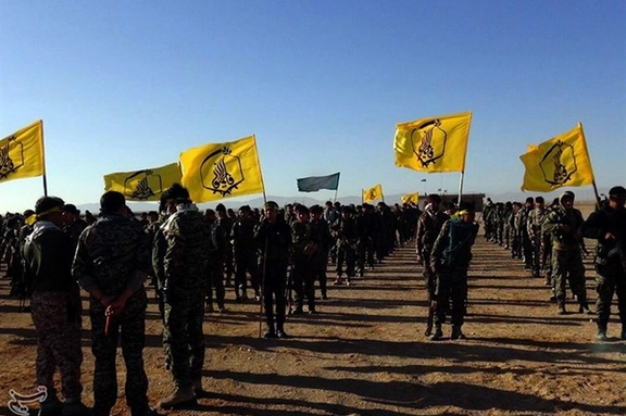 Fatemiyoun brigade fighters showcasing their flag in Syria