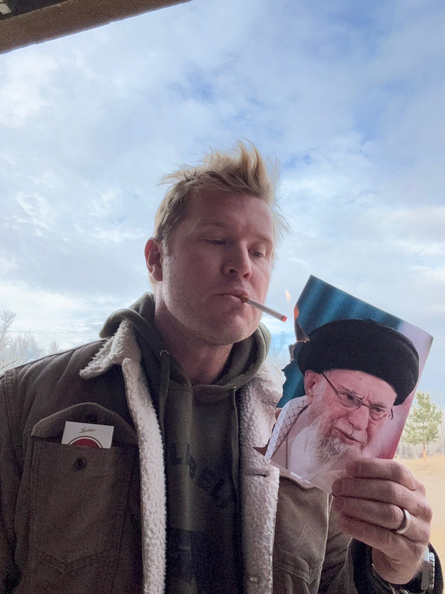 US senator posts photo lighting cigarette with burning image of Khamenei