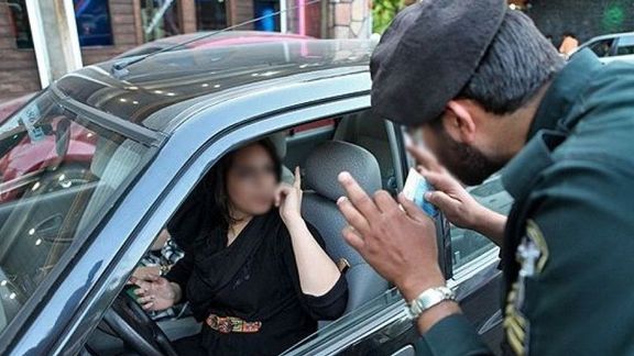 Woman arguing with a policeman in Tehran over her hijab. Undated