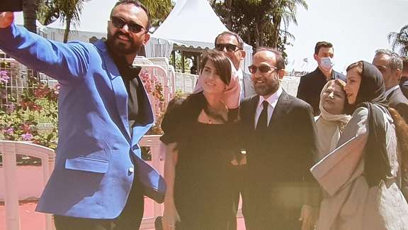 Asghar Farhadi (C) at a film festival in 2020