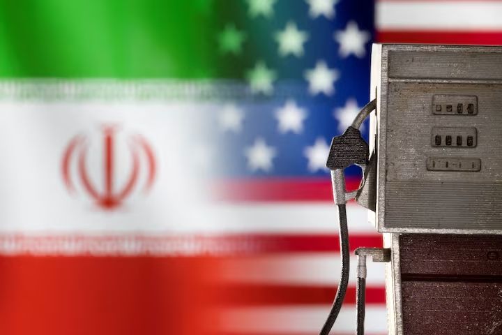 Model of petrol pump is seen in front of US and Iran flag colors in this illustration taken March 25, 2022.