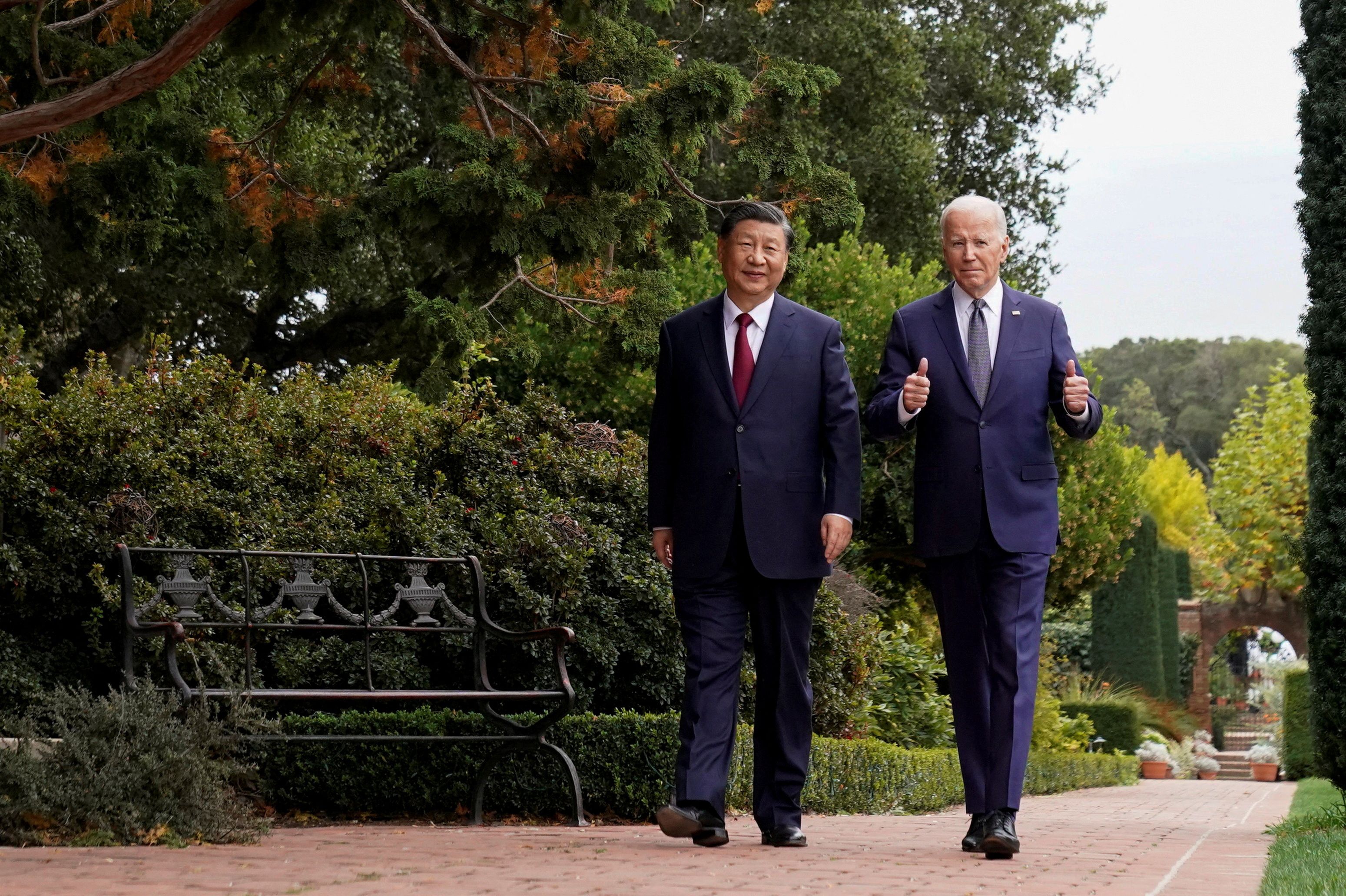 US President Joe Biden gives thumbs-up as he walks with Chinese President Xi Jinping at Filoli estate on the sidelines of the Asia-Pacific Economic Cooperation (APEC) summit, in Woodside, California, November 15, 2023. 