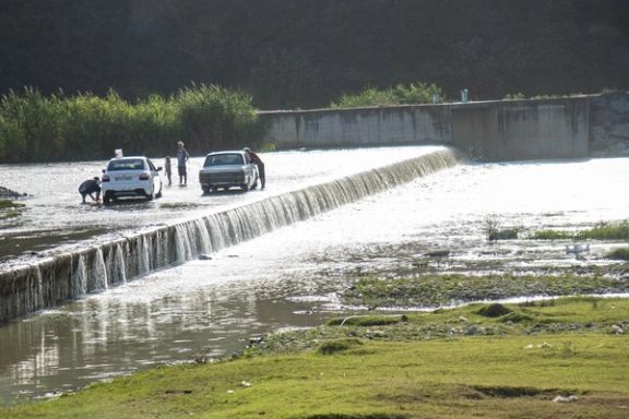 Iranians driving their cars into a shallow river to beat the summer heat near the Caspian city of Sari, July 23, 2025