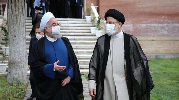 Iran former president Hassan Rouhani with Ebrahim Raisi on inauguration day.