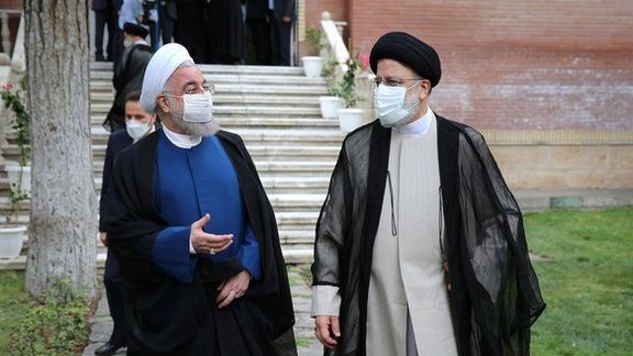Hassan Rouhani (L) handing over the government to Ebrahin Raisi in August 2021