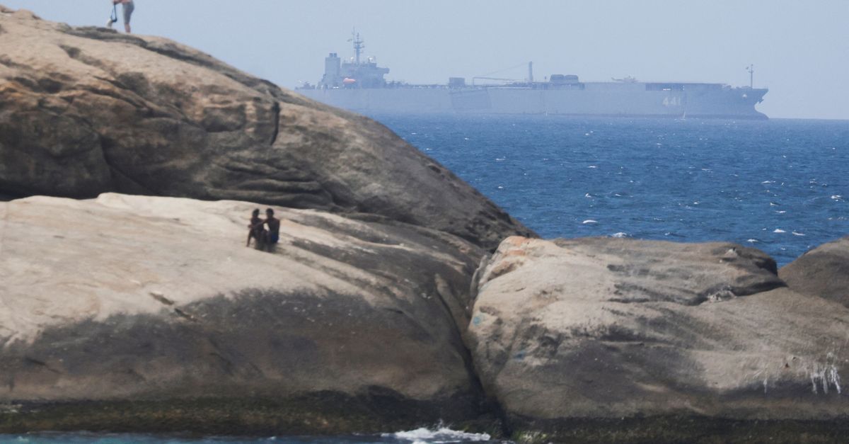 Iranian military ship Iris Makran navigates on the coast of Rio de Janeiro as beachgoers sunbathe on the stones of Arpoador Beach, Brazil, February 27, 2023.
