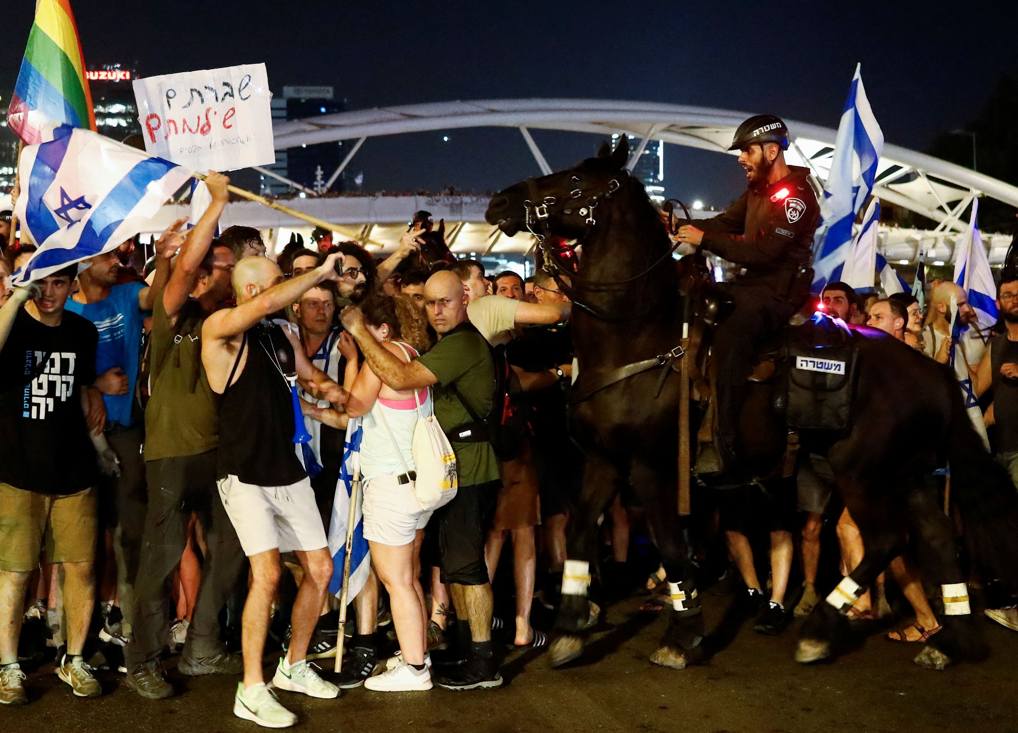 A mounted police officer scuffles with protesters blocking Ayalon Highway during a demonstration following a parliament vote on a contested bill that limits Supreme Court powers to void some government decisions, in Tel Aviv, Israel July 24, 2023.
