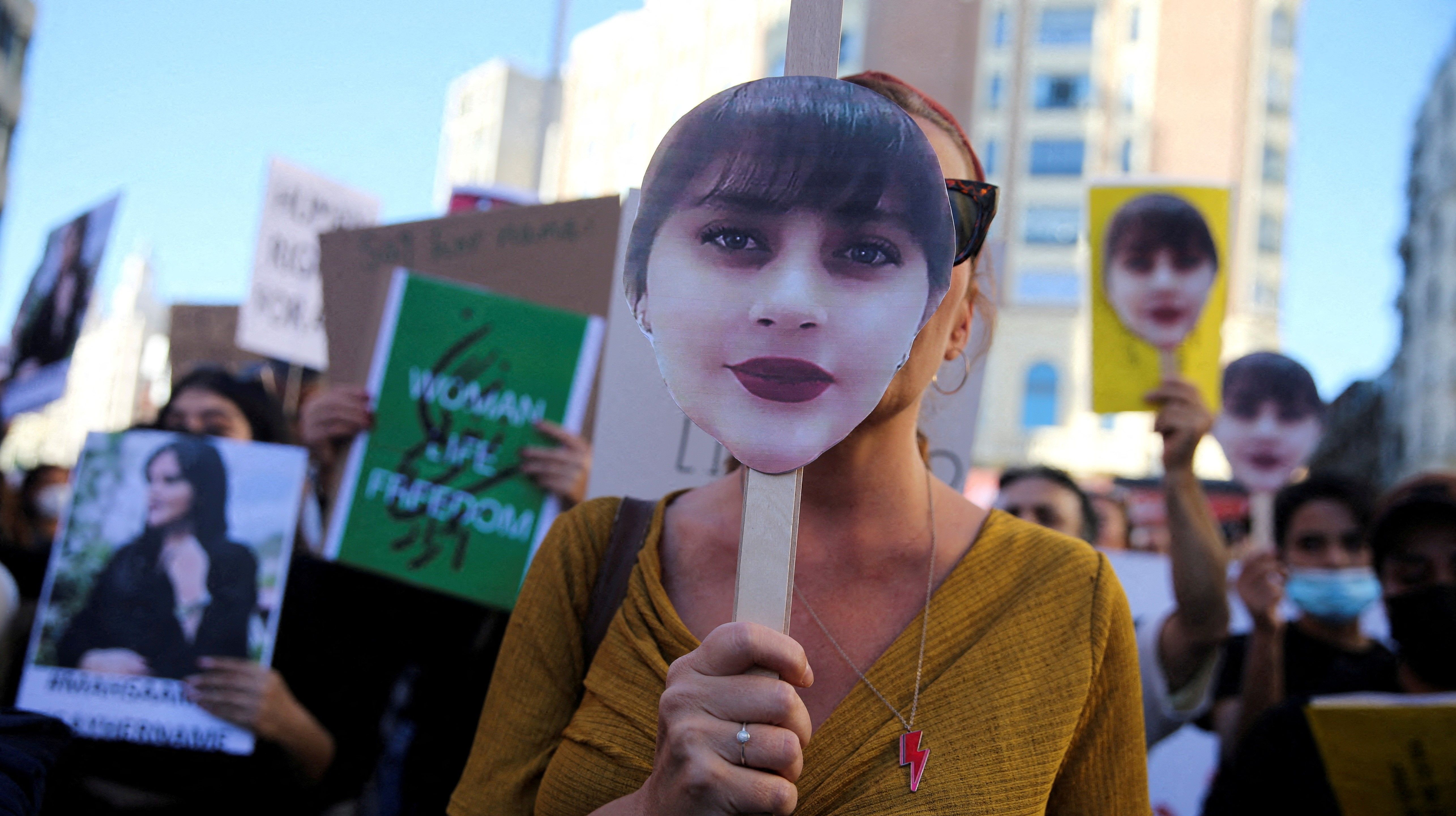 Protesters in Madrid, Spain, carrying images of Mahsa Amini, the young woman who was killed in police custody in Iran