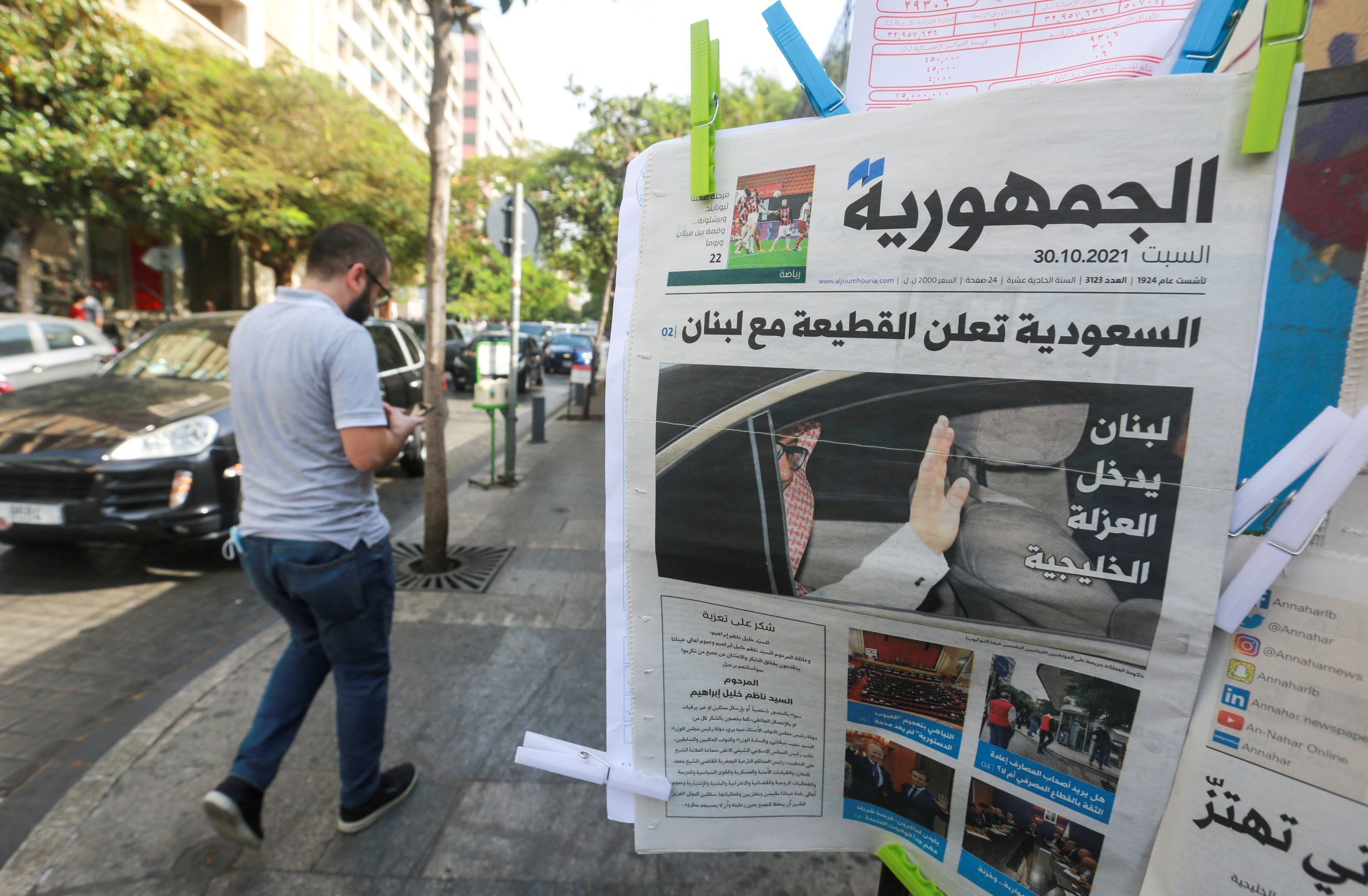 A man walks near a newspaper with a headline that reads " Saudi Arabia announces a boycott with Lebanon" in Beirut, October 30, 2021. 