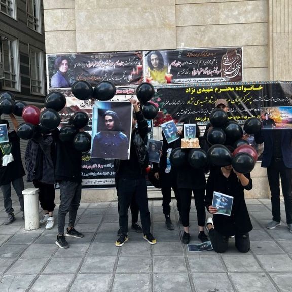 Mourners marking the death of Mehrshad Shahidi