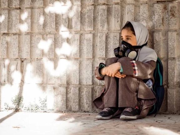 A schoolgirl breathing through a mask (file photo)