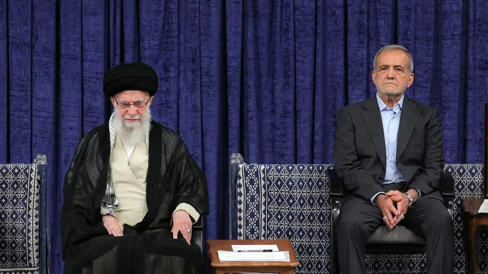 President Masoud Pezeshkian (right) sitting next to Supreme Leader Ali Khamenei (left) during a ceremony in Tehran. (Undated)