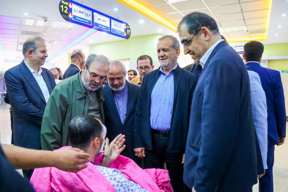 Iran's President Masoud Pezeshkian visits one of the victims injured by pager explosions across Lebanon, in a hospital in Tehran, Iran, September 20, 2024. 