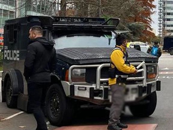 Armored police vehicles are seen outside the headquarters of Iran International on Nov. 19, 2022