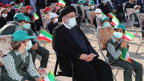 Iran’s President Ebrahim Raisi among a group of schoolboys in Tehran