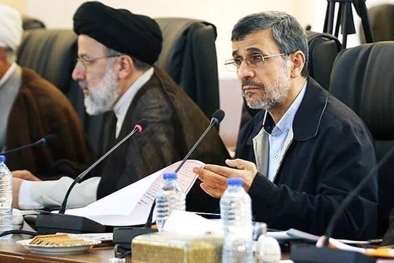 Former Iranian president Mahmoud Ahmadinejad (right) and President Ebrahim Raisi during a session