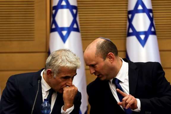 Israeli PM Naftali Bennet speaking with foreign minister Yair Lapid.