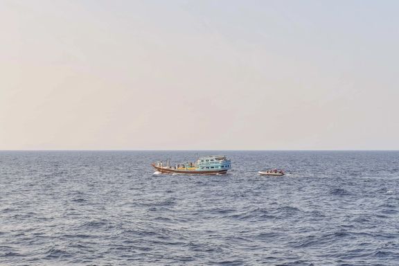 US naval forces approach a fishing vessel transiting international waters in the Gulf of Oman during an interdiction.