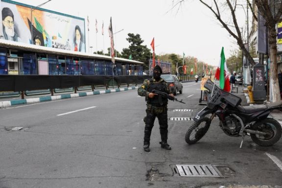 A member of a police force stands guard on a street in Tehran, Iran, March 23, 2026.