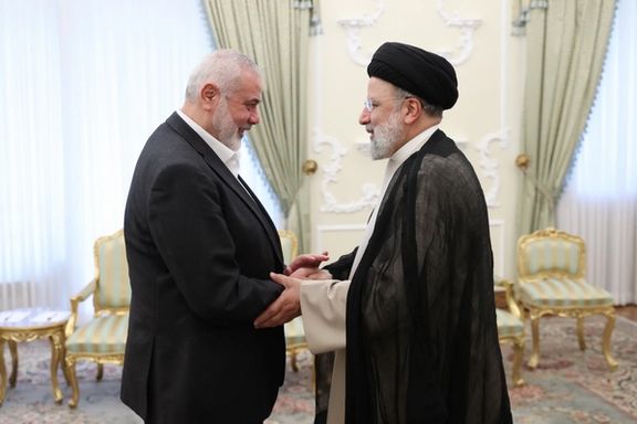 Iranian President Ebrahim Raisi (right) shaking hand with Ismail Haniyeh, the leader of Hamas Islamist group, during a meeting in Tehran on March 27, 2024