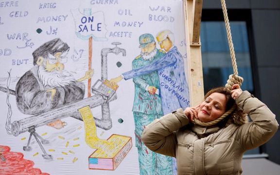 A woman plays the role of a person being hanged as Iranian community member takes part in a protest in solidarity with Iranian people, in Brussels, Belgium, February 20, 2023