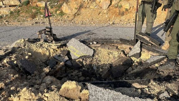A view of a crater on a damaged road, after Iran's mass drone and missile attack, at a location given as Hermon area, Israel, in this handout picture released on April 14, 2024.