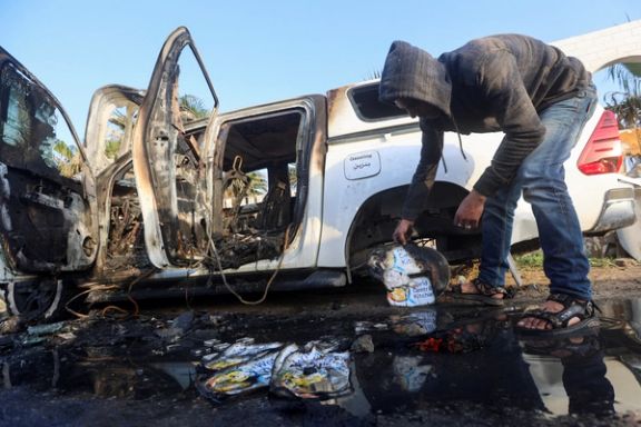 A Palestinian inspects near a vehicle where employees from the World Central Kitchen (WCK), including foreigners, were killed in an Israeli airstrike, in Deir Al-Balah, in the central Gaza, Strip April 2, 2024.