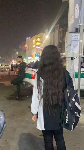 An Iranian woman unveiling in protest to the mandatory hijab