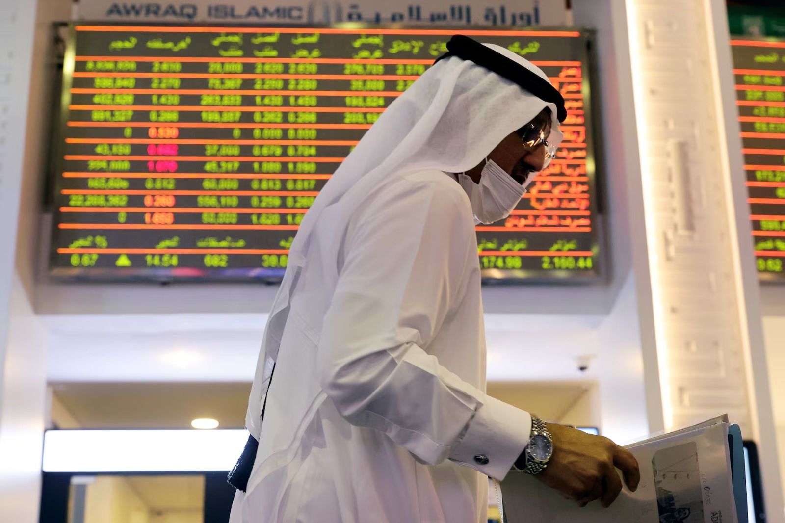 An investor walks through the Dubai Financial Market in Dubai, United Arab Emirates November 8, 2020.