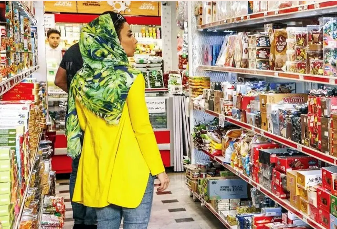 A woman shops for groceries in a store in Iran as prices continue to rise.