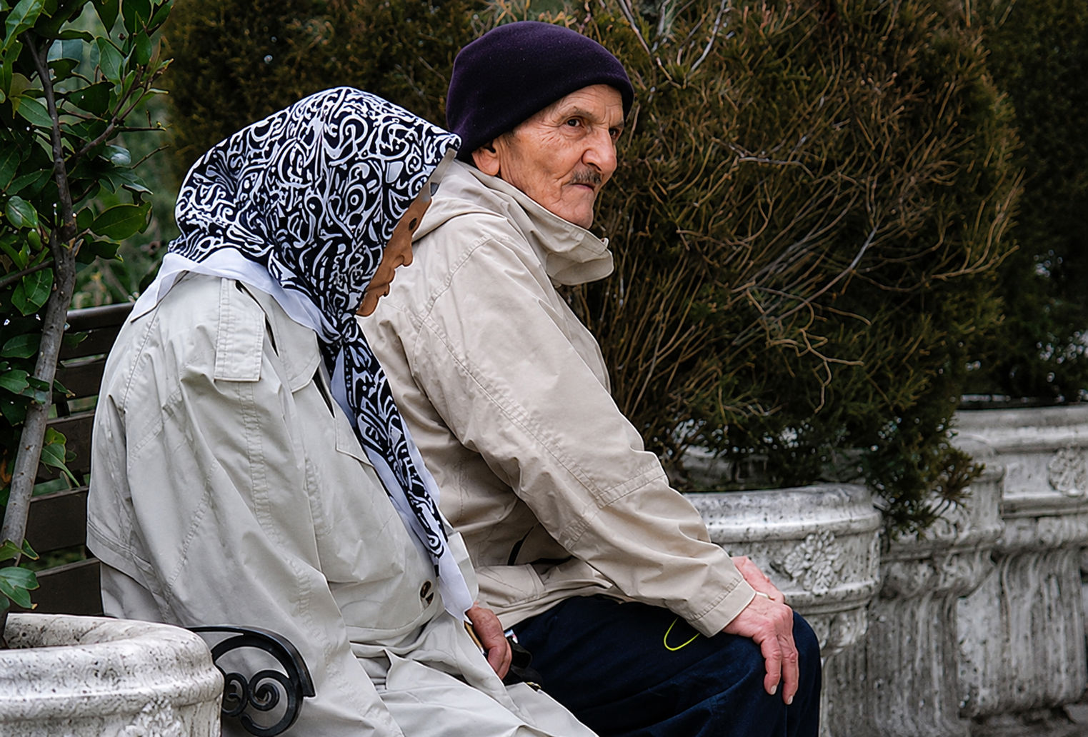 An elderly couple sits on a park bench in Iran. (undated)
