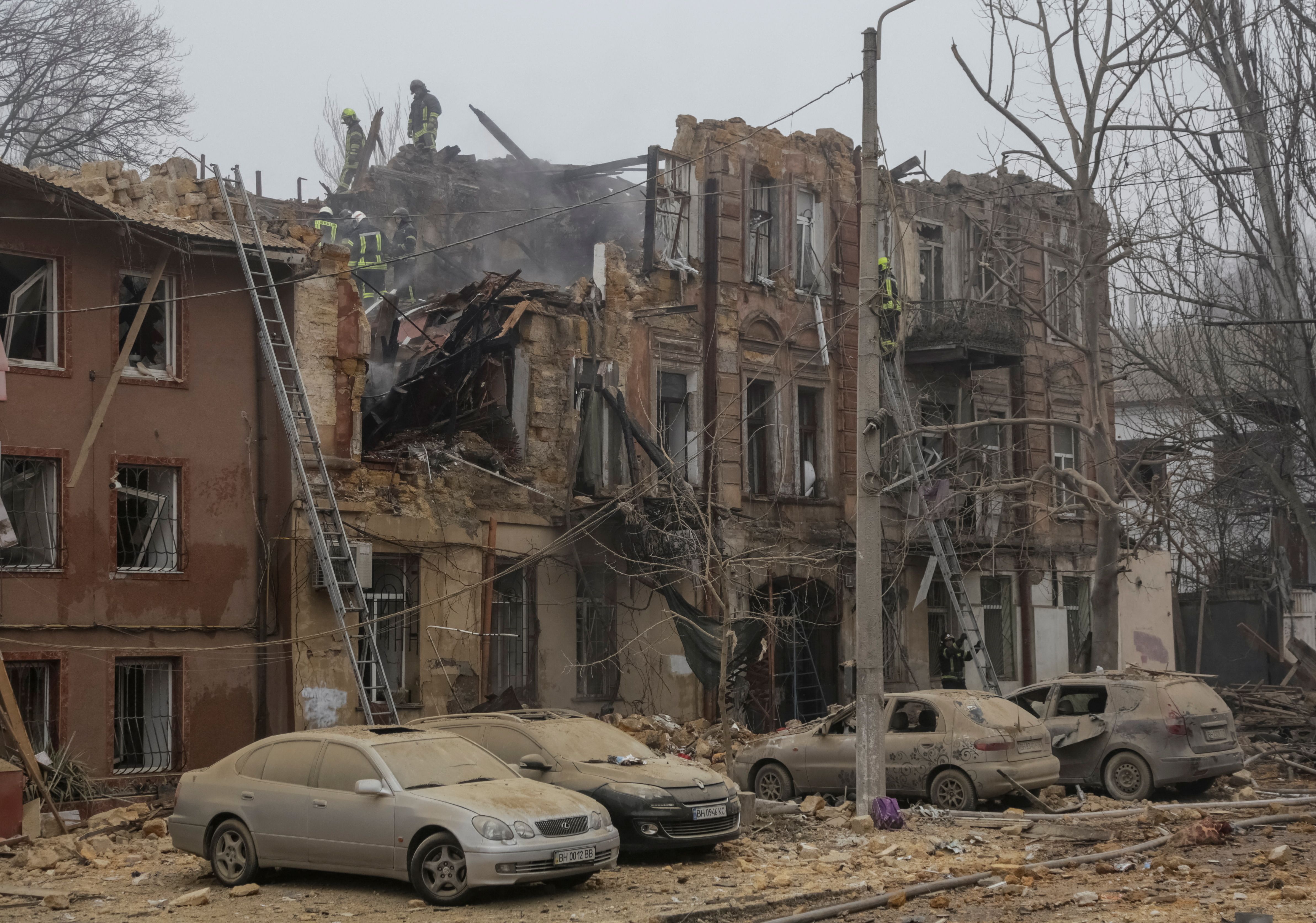 Emergency service members work at a residential building destroyed during a Russian missile and drone strike, amid Russia's attack on Ukraine, in Odesa, Ukraine December 29, 2023. 