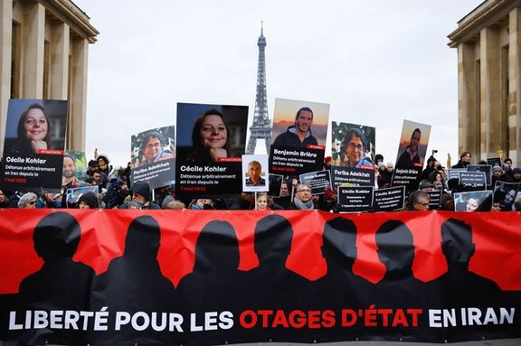 Supporters and relatives of French citizens detained in Iran, Cecile Kohler, Benjamin Briere, Jacques Paris and Fariba Adelkhah, gather in front of the Eiffel Tower, during a rally demanding their release, in Paris, France, January 28, 2023.