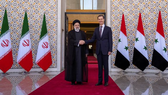 Syria's President Bashar al-Assad stands with Iranian President Ebrahim Raisi in Damascus, Syria, in this handout released by SANA on May 3, 2023.