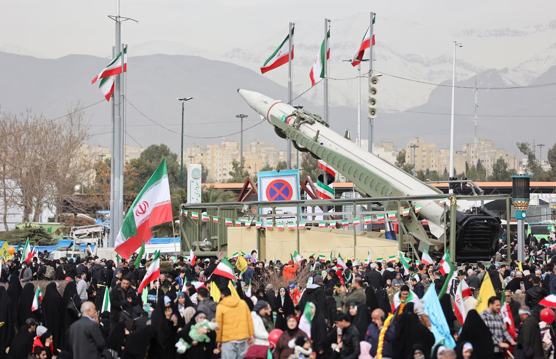 People gather near a missile on display during the 47th anniversary of the Islamic Revolution in Tehran, Iran February 11, 2026.