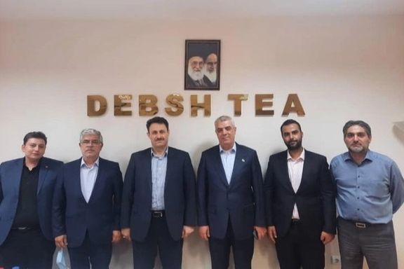 Debsh Tea Company CEO Akbar Rahimi (4th left) among a group of the company’s employees