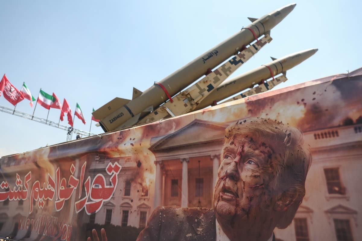 A banner with a threat against President Trump's life is displayed beneath missiles during a state-organized event in Tehran's Azadi Square, Iran, July 30, 2026
