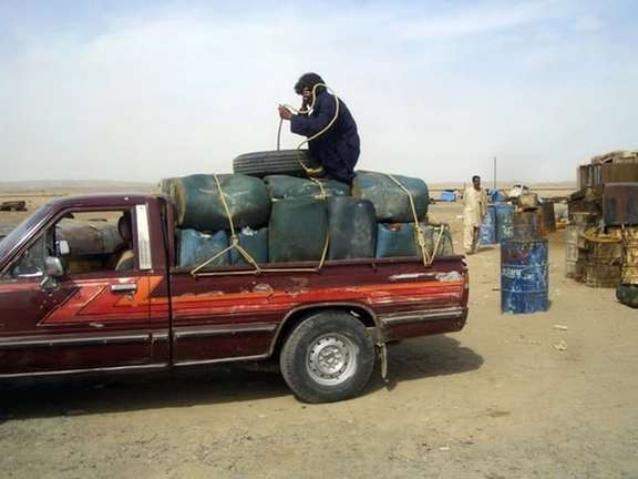 A pickup truck loaded with canisters of gasoline destined for Pakistan