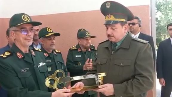 Chief of staff of the Islamic Republic's armed forces Major General Mohammad Baqeri (L) handing a symbolic key to Tajik defense minister Colonel General Sherali Mirzo during the opening ceremony of a drone manufacturing plant in Tajikistan’s capital Dushanbe on May 17, 2022