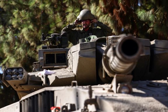 An Israeli soldier sits in a tank near Israel's border with Lebanon, in northern Israel, October 25, 2023.