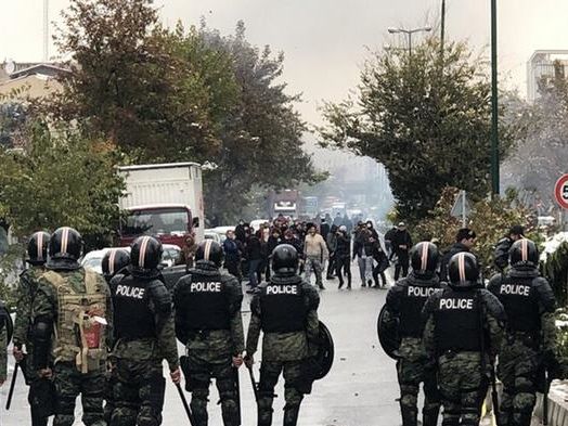 Riot police against protesters in Tehran during 2019 protests