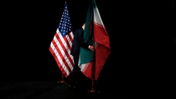 A staff member removes the Iranian flag from the stage after a group picture with foreign ministers and representatives of the U.S., Iran, China, Russia, Britain, Germany, France and the European Union during the Iran nuclear talks at the Vienna International Center in Vienna, Austria July 14, 2015.