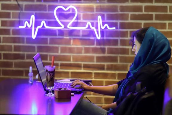 An Iranian woman sits in a cafe after the launching of the "Hamdam" dating app, in Tehran, Iran, July 17, 2021.