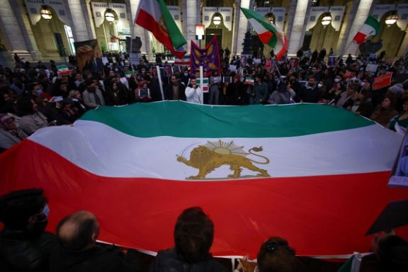 People hold the "Lion and Sun" pre-Iranian Revolution national flag during a rally in support of nationwide protests in Iran, in Rome, Italy, January 13, 2026.