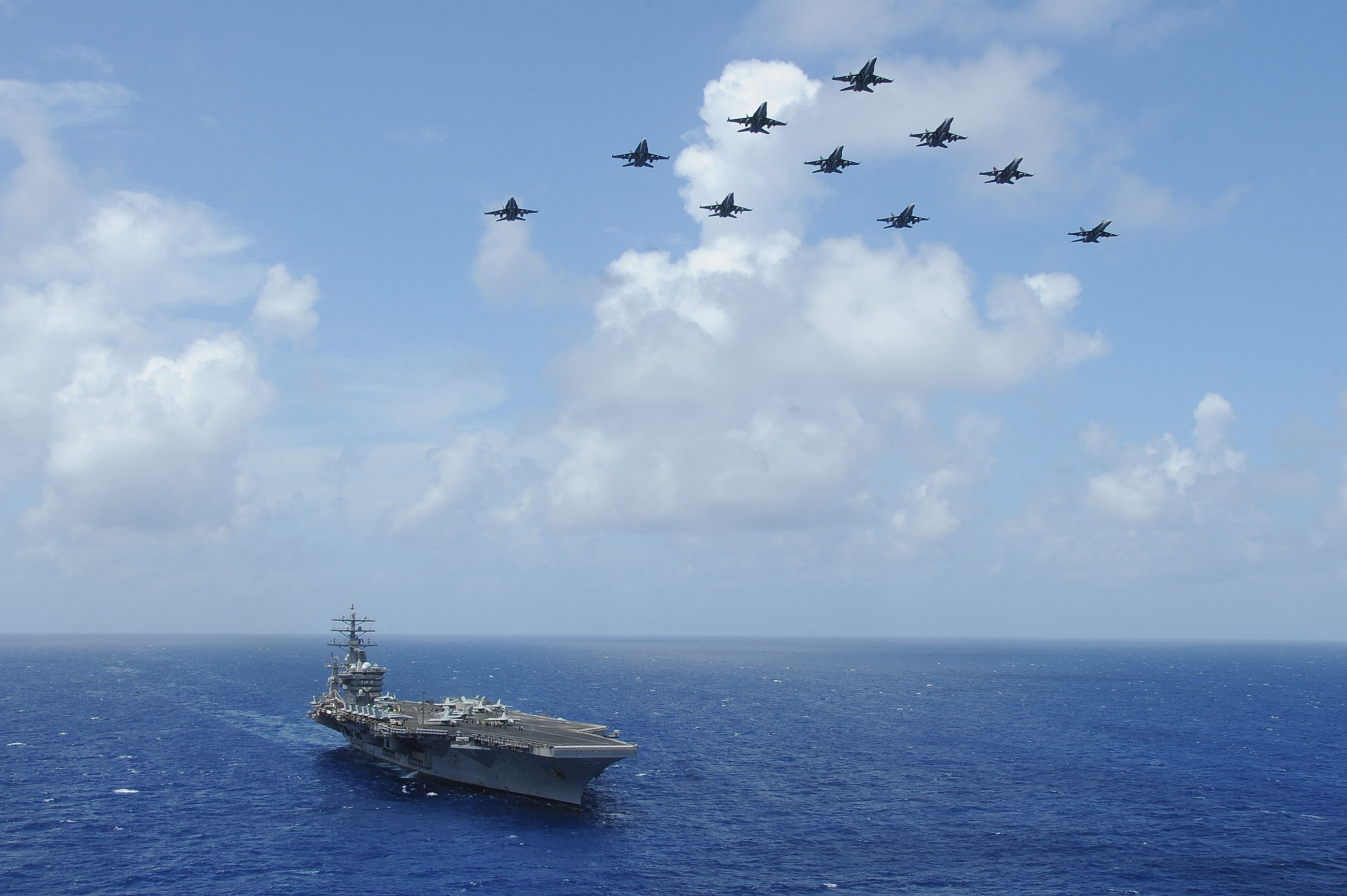 Handout photo dated July 2, 2013 shows F/A-18C Hornets assigned to the Wildcats of Strike Fighter Squadron (VFA) 131 fly over the aircraft carrier USS Dwight D. Eisenhower (CVN 69) during Carrier Air Wing (CVW) 7’s fly-off in the Atlantic Ocean. 