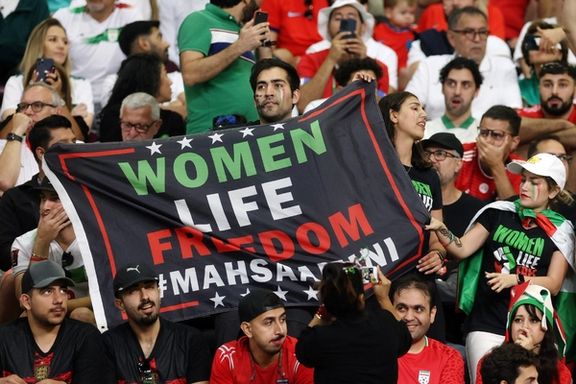 Iran fans hold a banner reading 'Woman life freedom' inside the stadium during the match against England on November 21, 2022.