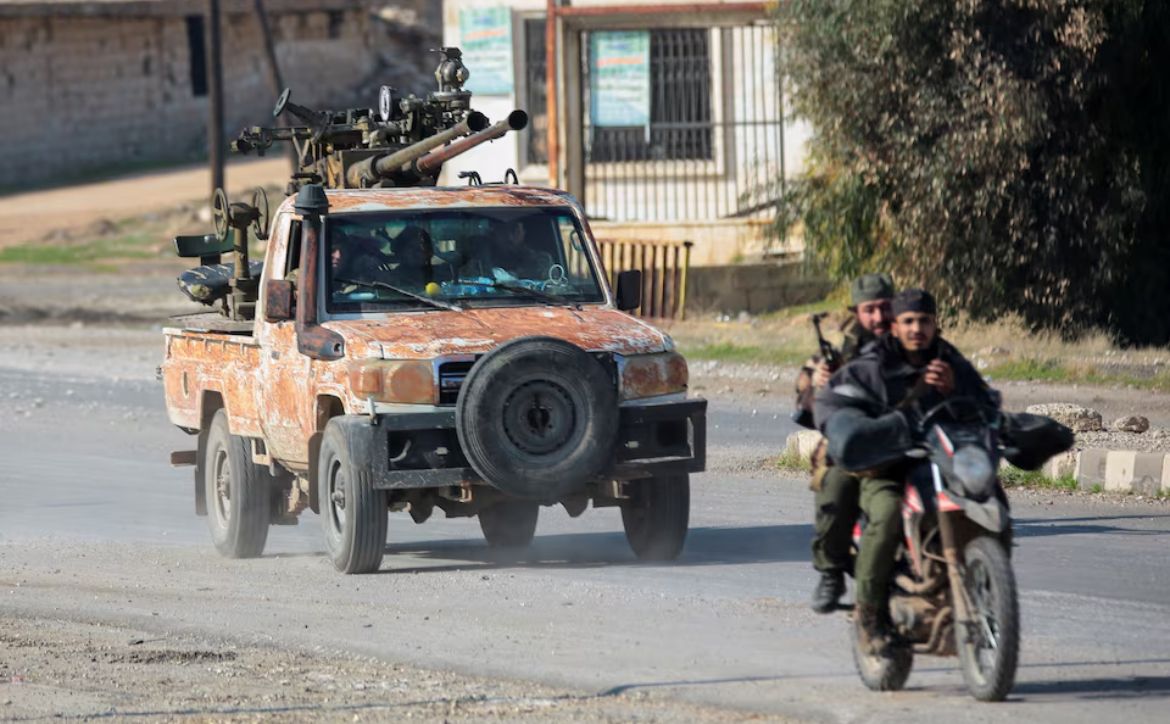 Rebels led by the Islamist militant group Hayat Tahrir al-Sham drive on a motorbike in al-Rashideen, Aleppo province, Syria November 29, 2024.