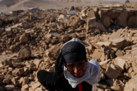 An Afghan woman stands next to her house after the recent earthquake in Herat province, Afghanistan, October 11, 2023.