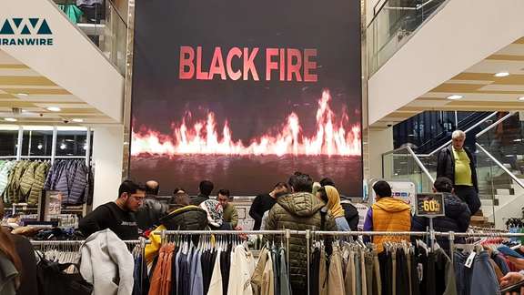 Iranians shopping clothes at a store in Tehran