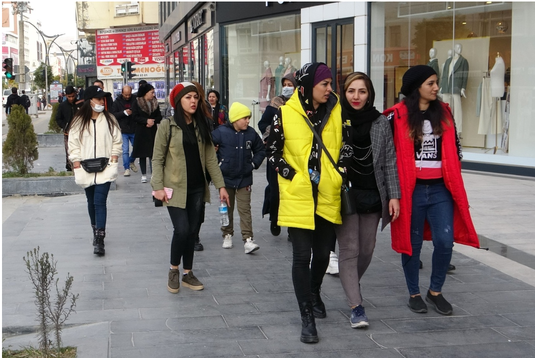 File photo shows pedestrians walking along a shopping street in the Turkish city of Van, a popular destination for Iranian visitors.